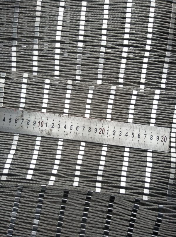 A ruler is used to check the rope mesh ferrule spacing.