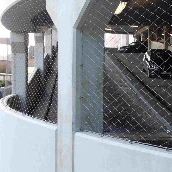Frameless rope mesh system is installed on the parking lot fence.
