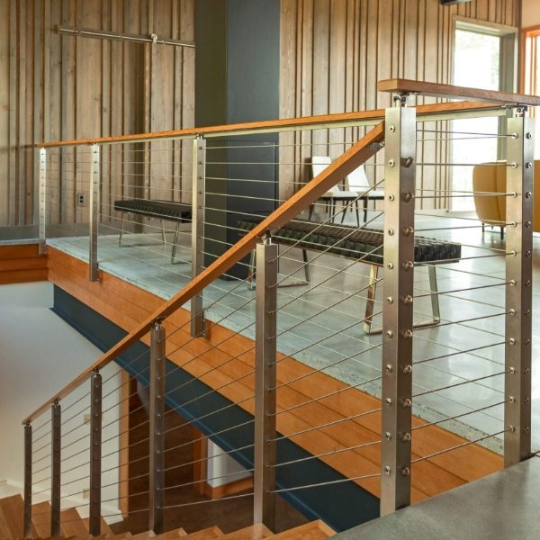 Stainless steel rope systems act as indoor staircase infill.